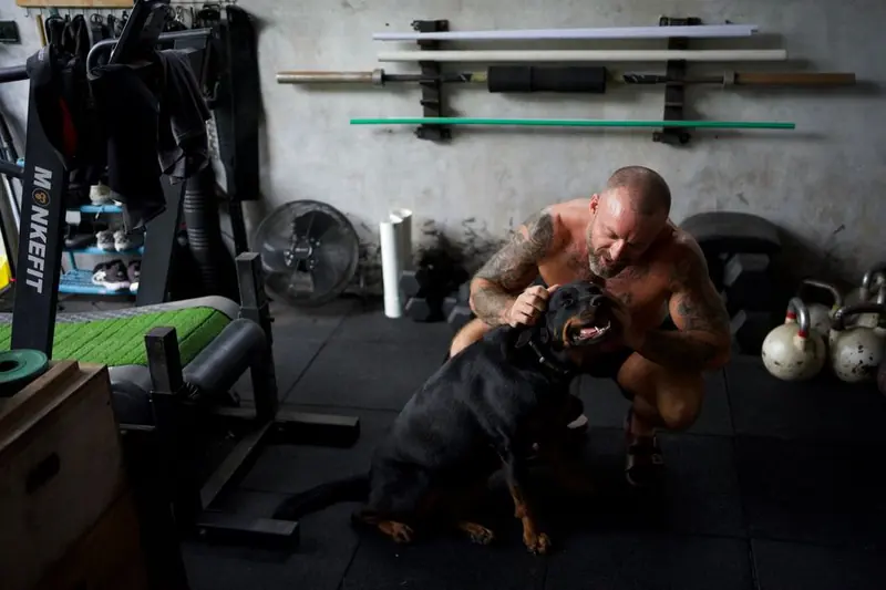 Coach Boltz with his dog in the home gym